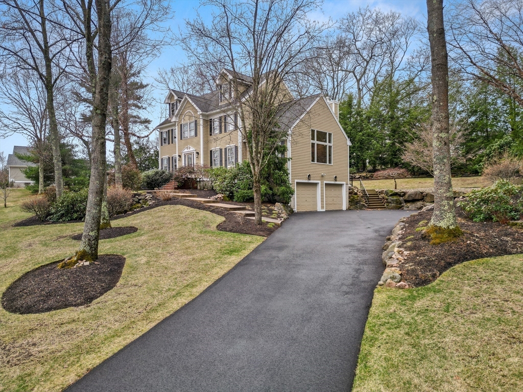7 Derosier Drive Middleton, MA 01949 - Photo 2 of 42 a front view of a house with a yard and trees