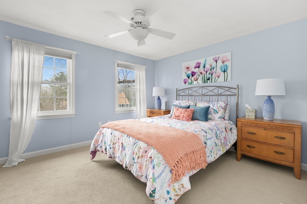 7 Derosier Drive Middleton, MA 01949 - Photo 26 of 42 a bedroom with a bed and a chandelier