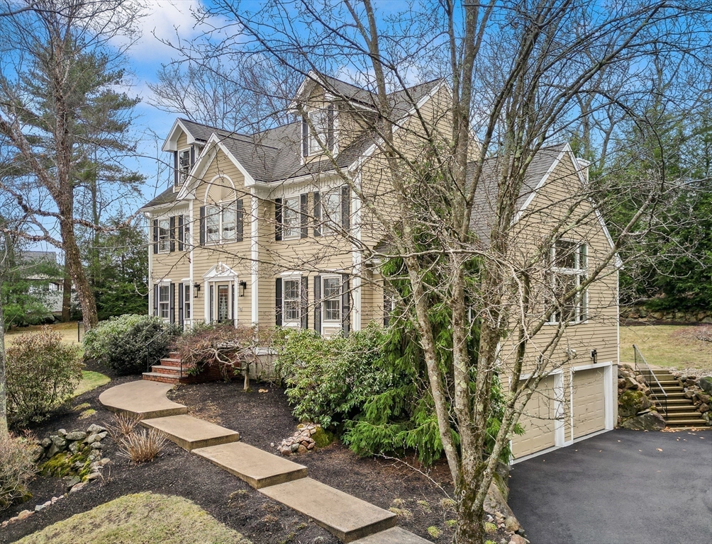 7 Derosier Drive Middleton, MA 01949 - Photo 3 of 42 a front view of a house with garden