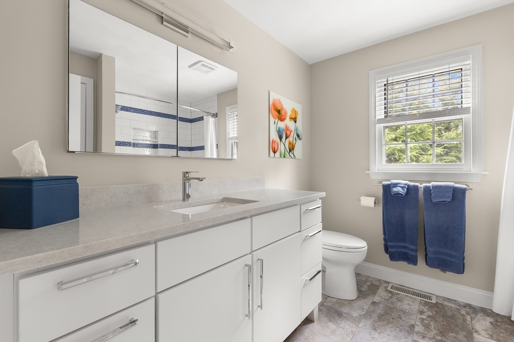 7 Derosier Drive Middleton, MA 01949 - Photo 31 of 42 a bathroom with a toilet sink and mirror