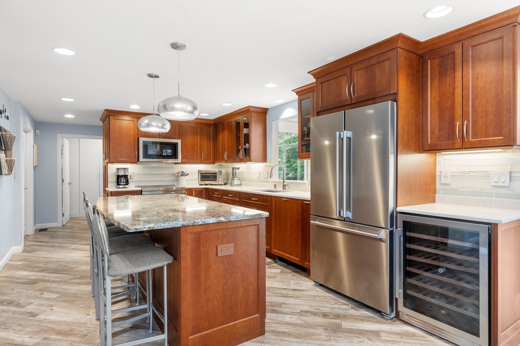 7 Derosier Drive Middleton, MA 01949 - Photo 9 of 42 a kitchen with stainless steel appliances granite countertop a refrigerator a oven and a sink with wooden floor