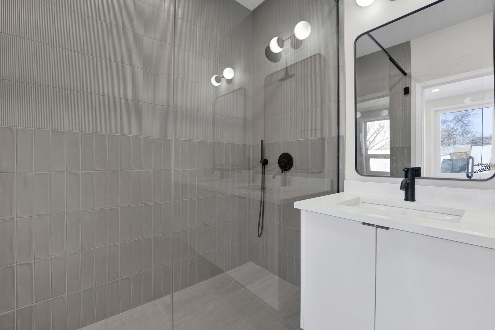 944 Beloit Avenue, Unit 4 Forest Park, IL 60130 - Photo 21 of 31 a bathroom with a granite countertop sink a mirror and shower