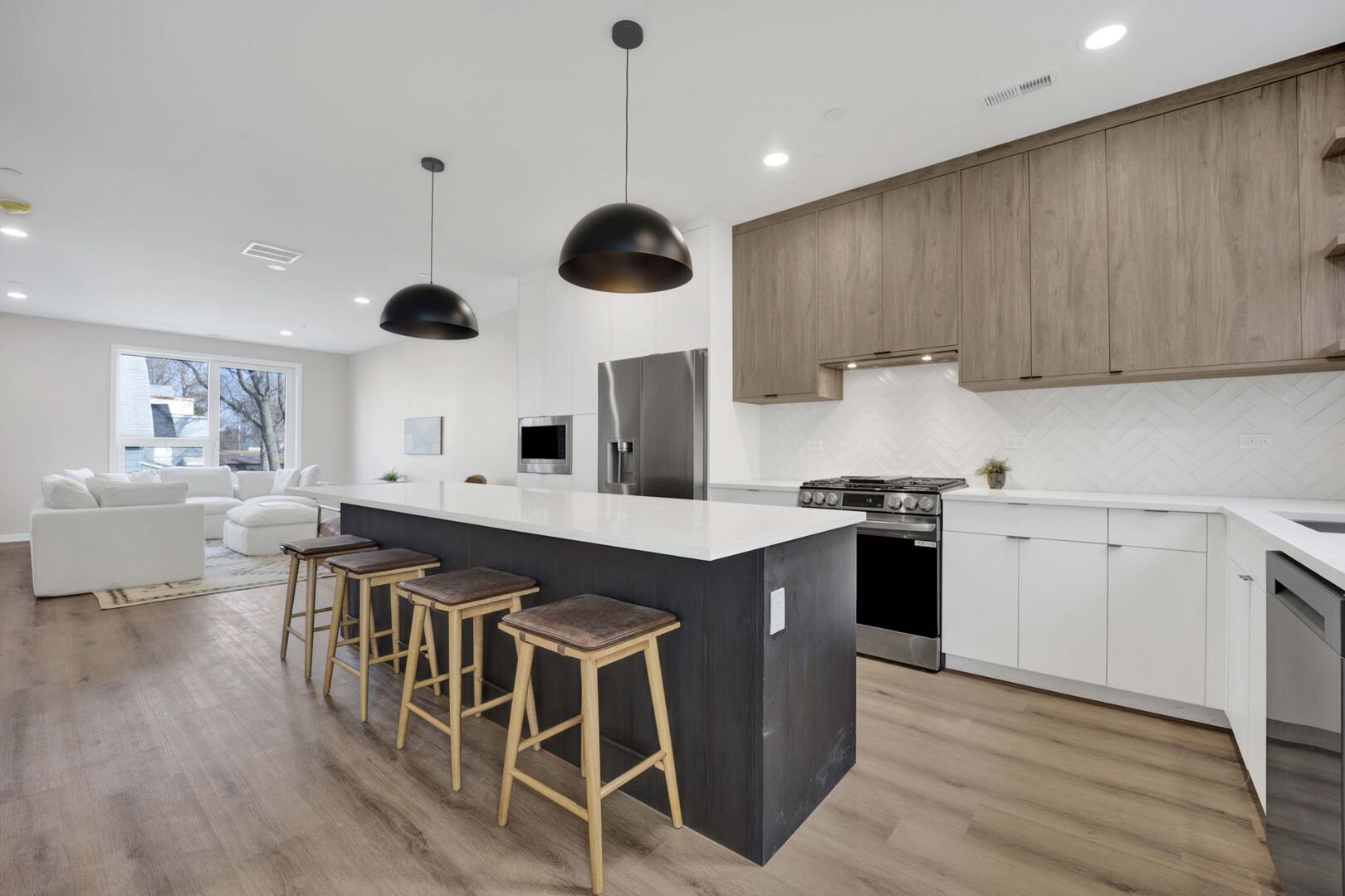 944 Beloit Avenue, Unit 4 Forest Park, IL 60130 - Photo 8 of 31 a kitchen with a stove a kitchen island with wooden cabinets and stainless steel appliances