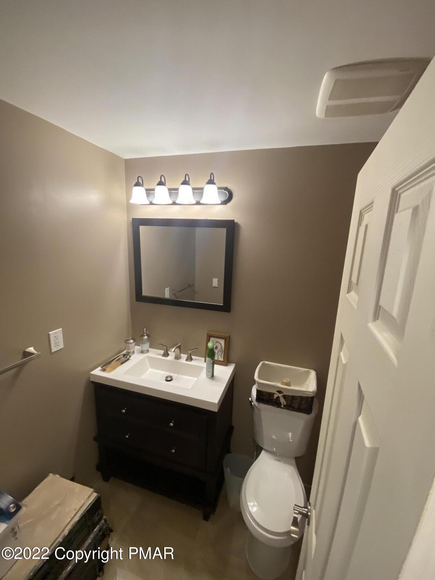 4698 Pine Ridge Drive West Bushkill, PA 18324 - Photo 14 of 17 a bathroom with a toilet sink and mirror