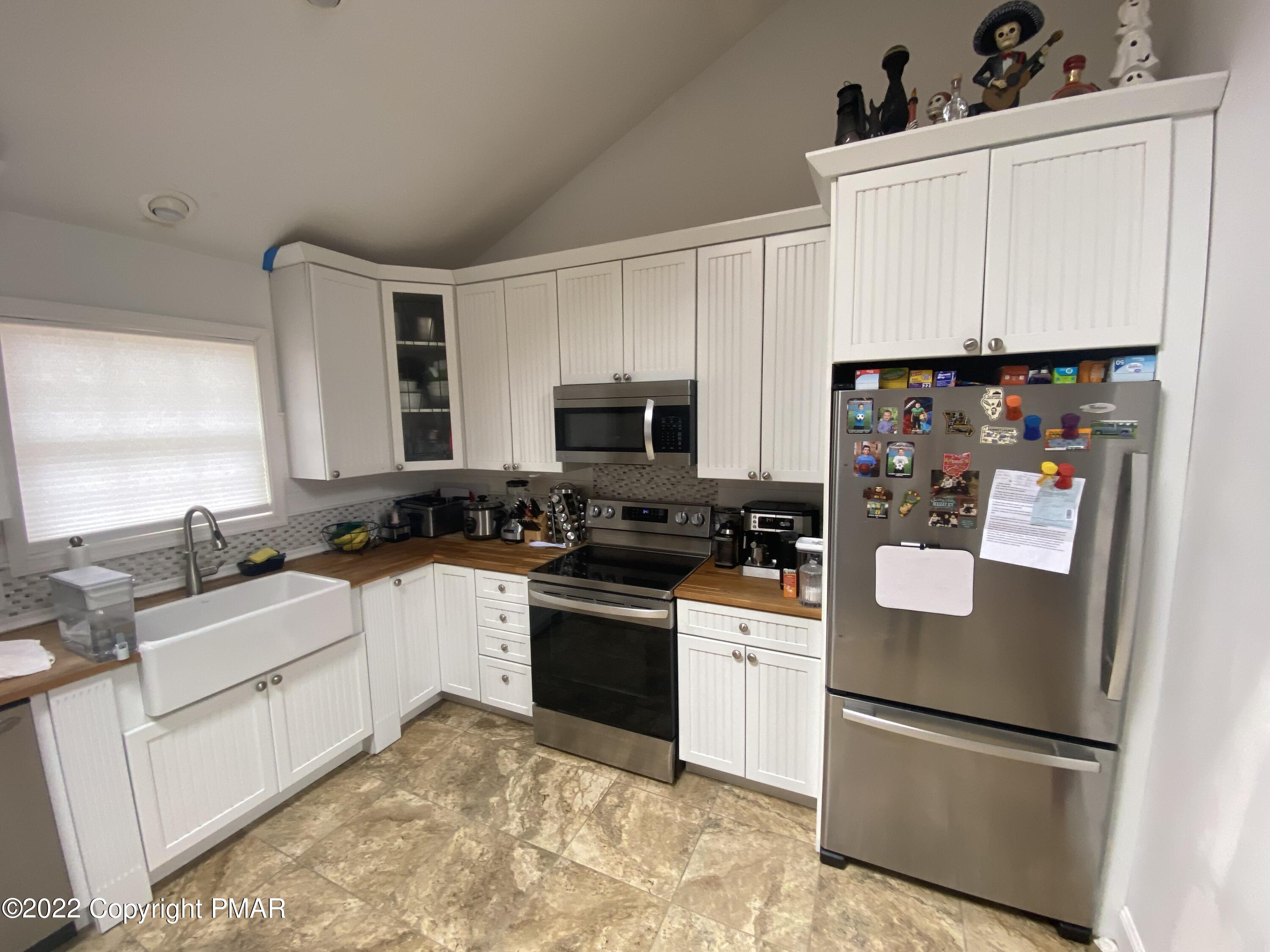 4698 Pine Ridge Drive West Bushkill, PA 18324 - Photo 3 of 17 a kitchen with white cabinets and refrigerator