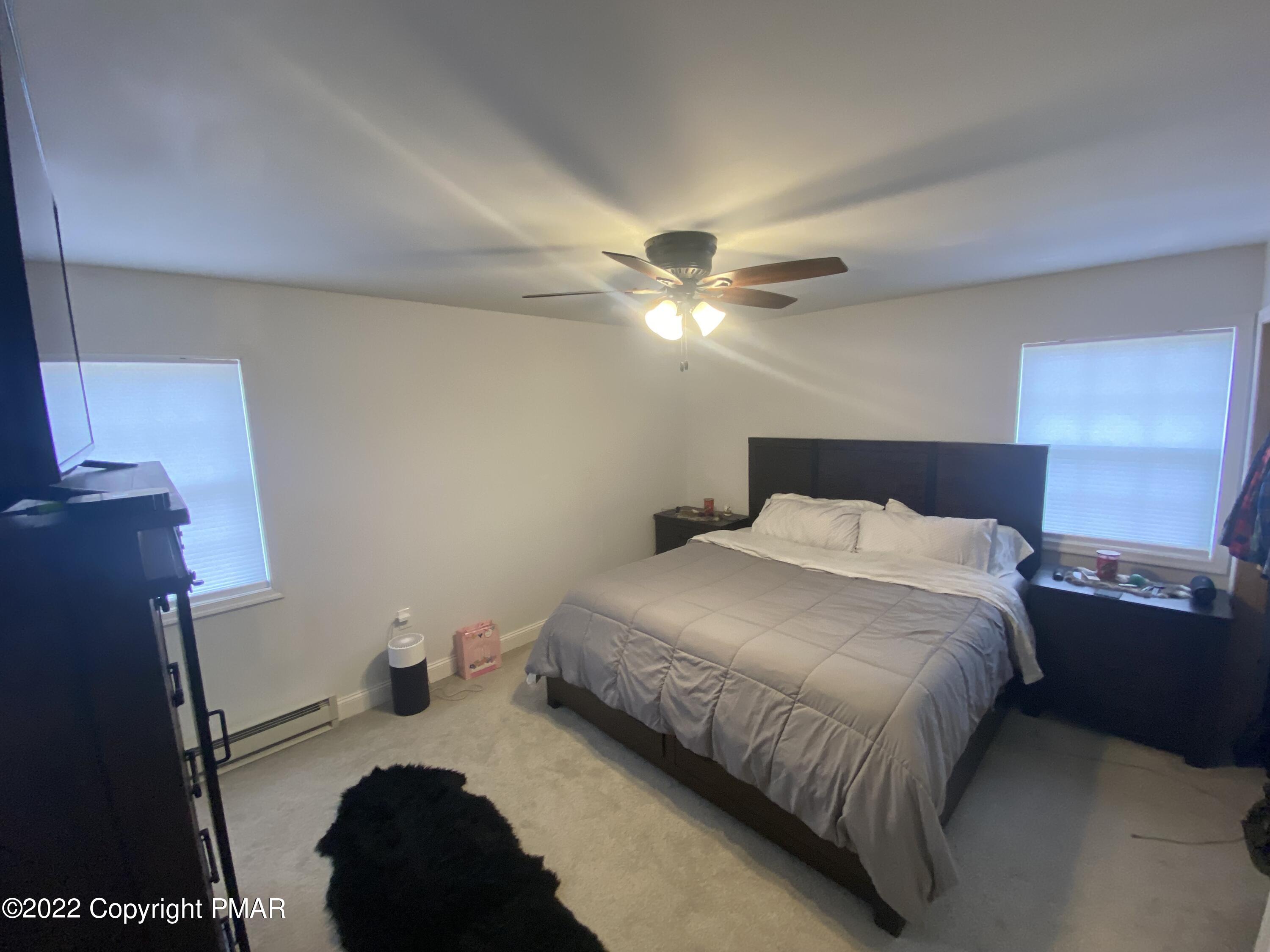4698 Pine Ridge Drive West Bushkill, PA 18324 - Photo 6 of 17 a bedroom with a bed and a chandelier