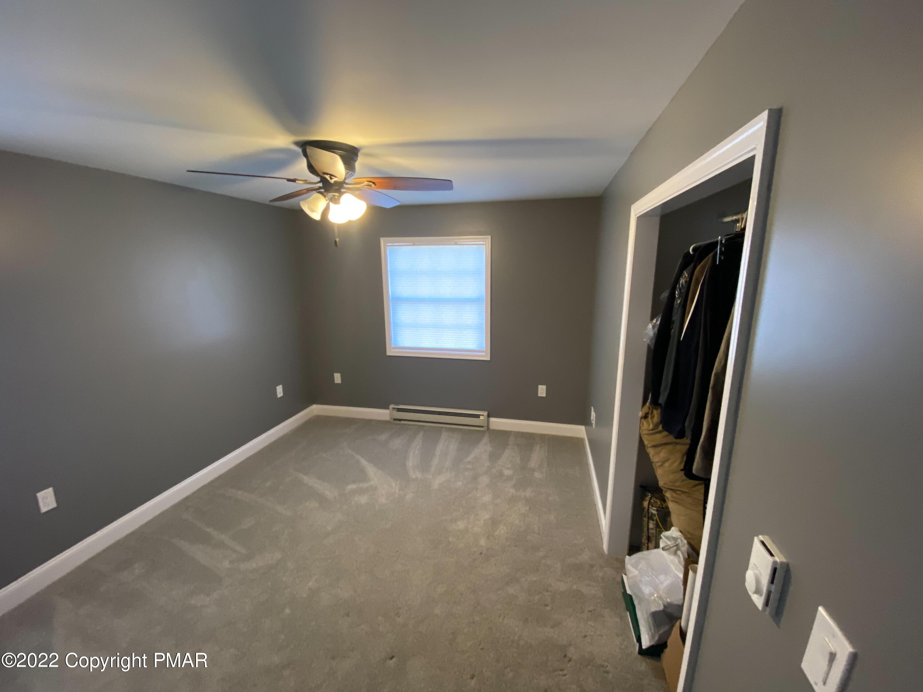 4698 Pine Ridge Drive West Bushkill, PA 18324 - Photo 7 of 17 an empty room with windows and fan