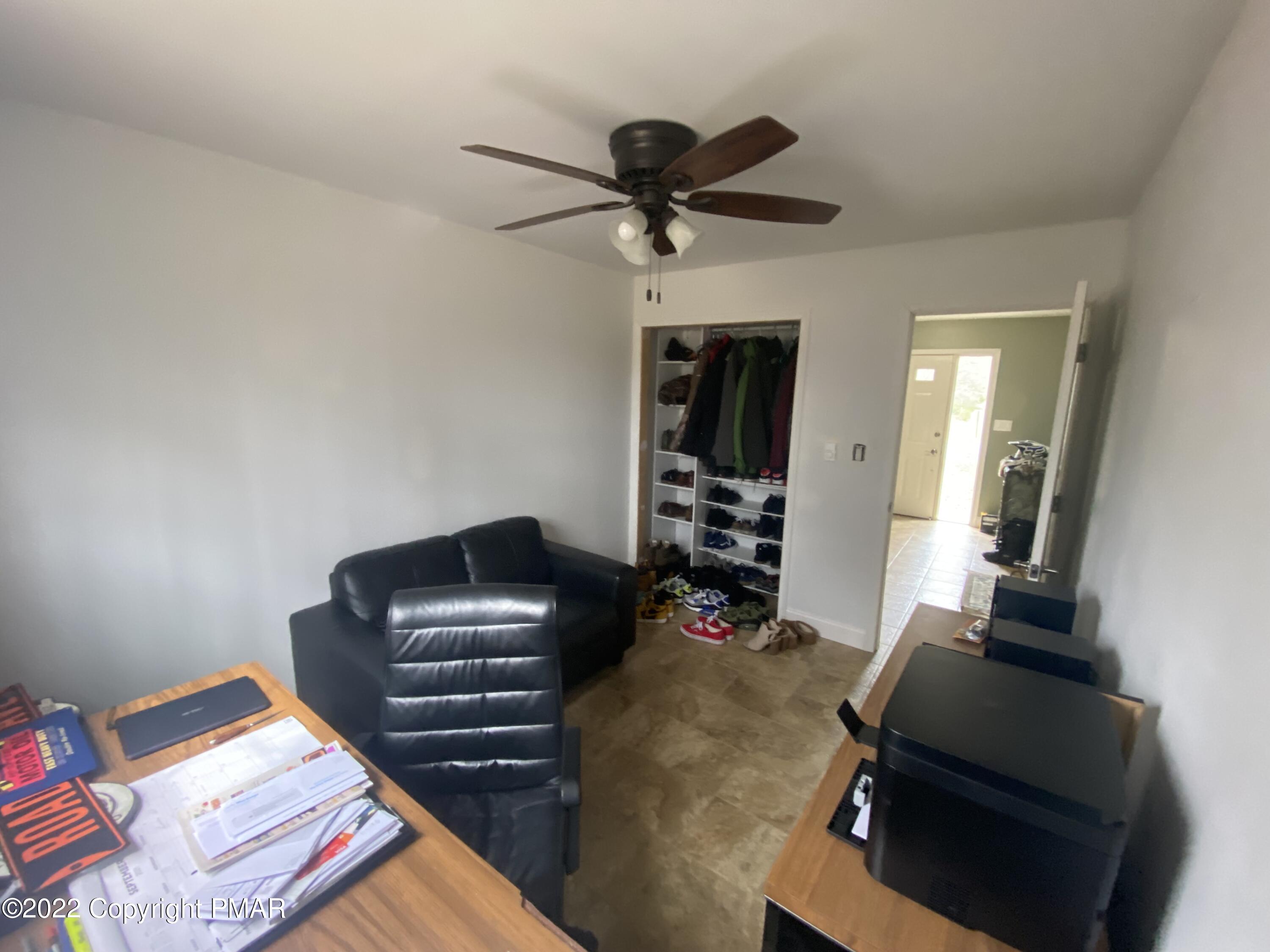 4698 Pine Ridge Drive West Bushkill, PA 18324 - Photo 8 of 17 a room with furniture and a ceiling fan