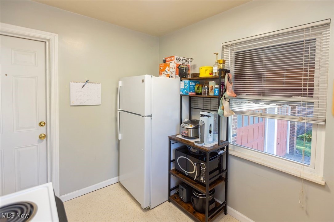 15537 Munn Road Cleveland, OH 44111 - Photo 15 of 38 Down unit Kitchen with baseboards and white appliances