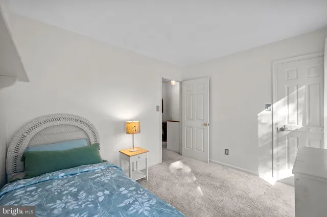 a view of a livingroom with wooden floor and a bench