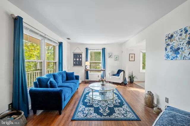 a living room with furniture rug and a large window