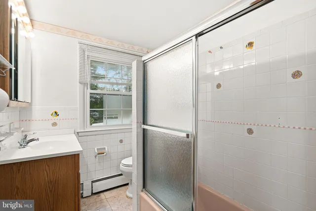 a bathroom with a shower sink and mirror
