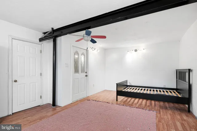 a bedroom with a bed and a book shelf