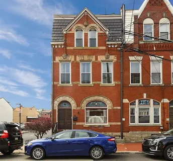 a front view of a house with parking space