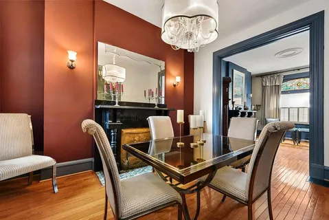 a dining room with furniture and wooden floor