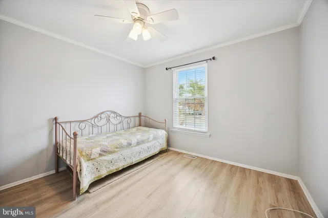 a spacious bedroom with a bed and a window