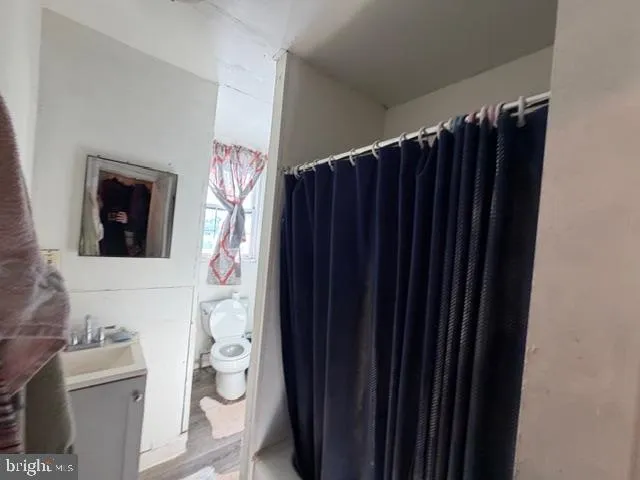 a bathroom with a toilet a sink and a shower