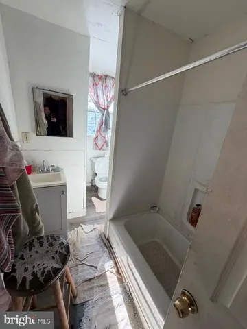 a bathroom with a bathtub and shower