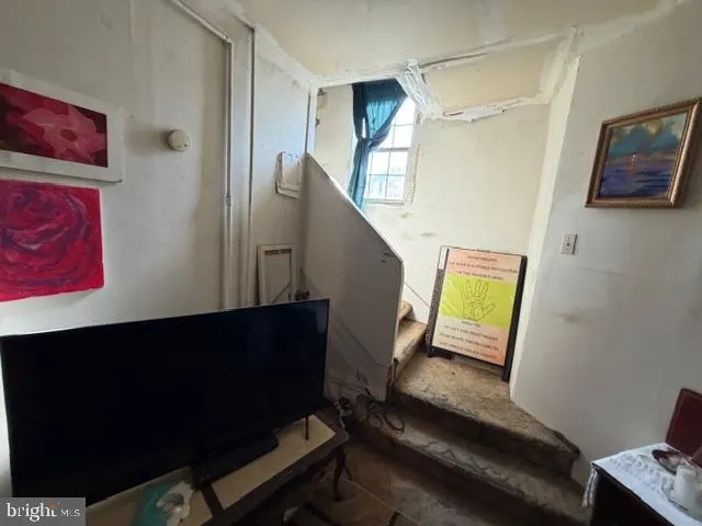 a view of a livingroom with furniture and a flat screen tv