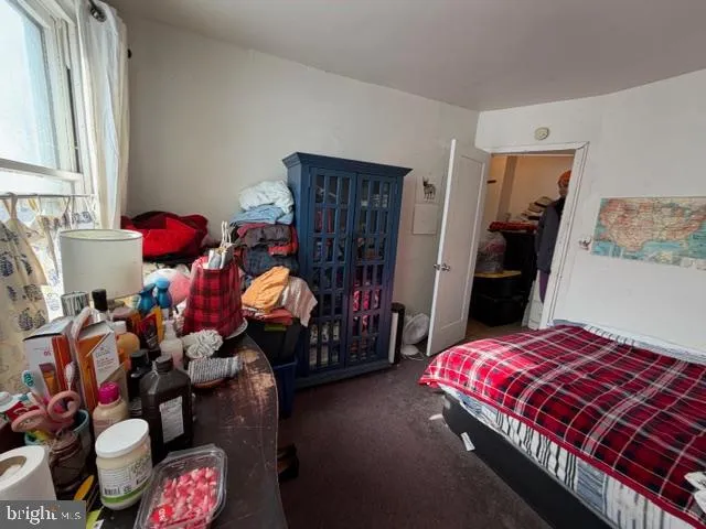 a bedroom with bed and window