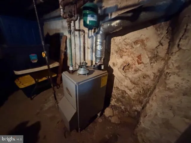 a room with water heater and wooden walls