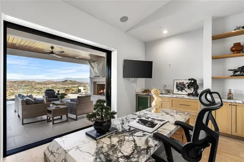 a spacious bedroom with a bed and a flat screen tv