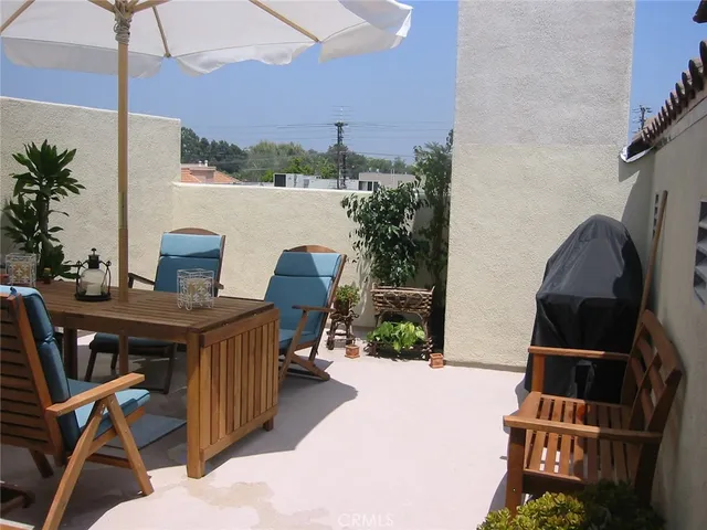 a balcony with table and chairs