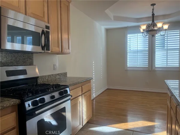 a kitchen with granite countertop a stove and a sink