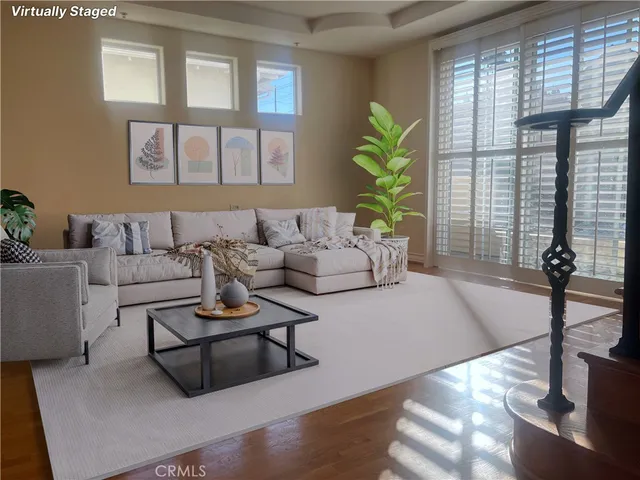 a living room with furniture and a potted plant
