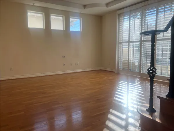 a view of a room with wooden floor and a window