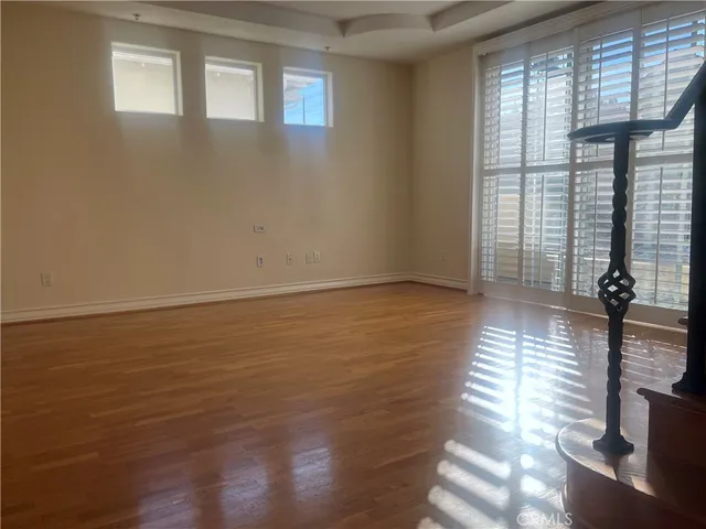 a view of a room with wooden floor and a window