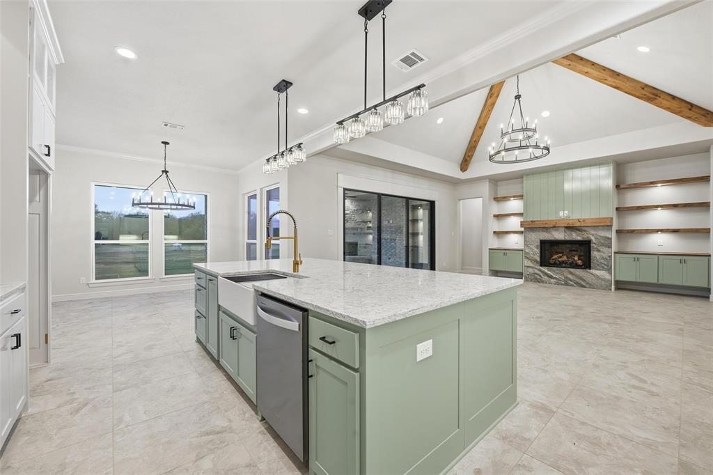 189 Rio Rancho Drive Decatur, TX 76234 - Photo 12 of 34 Kitchen featuring green cabinetry, a chandelier, a premium fireplace, white cabinetry, and recessed lighting