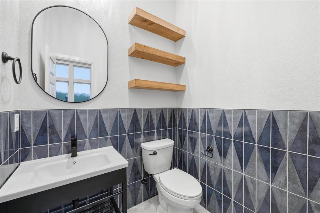 189 Rio Rancho Drive Decatur, TX 76234 - Photo 24 of 36 Bathroom featuring tile walls, a wainscoted wall, and a textured wall