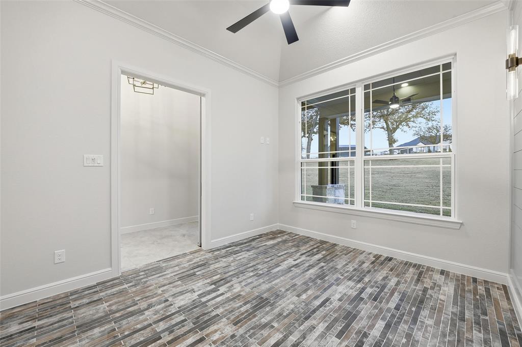 189 Rio Rancho Drive Decatur, TX 76234 - Photo 7 of 34 Empty room with ornamental molding and a ceiling fan