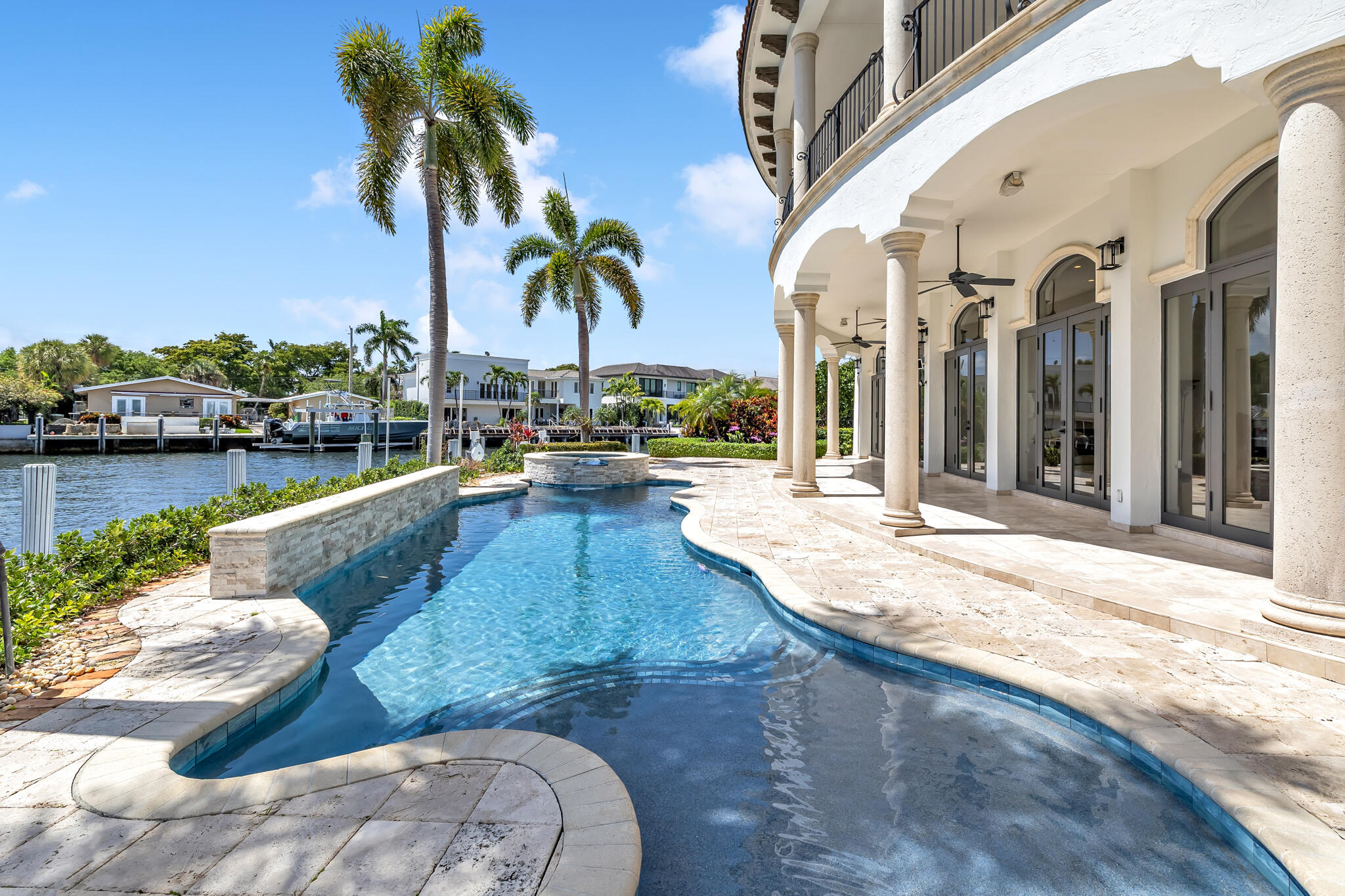 3700 Northeast 28th Avenue Lighthouse Point, FL 33064 - Photo 12 of 77 a view of a swimming pool with a lounge chair and palm trees