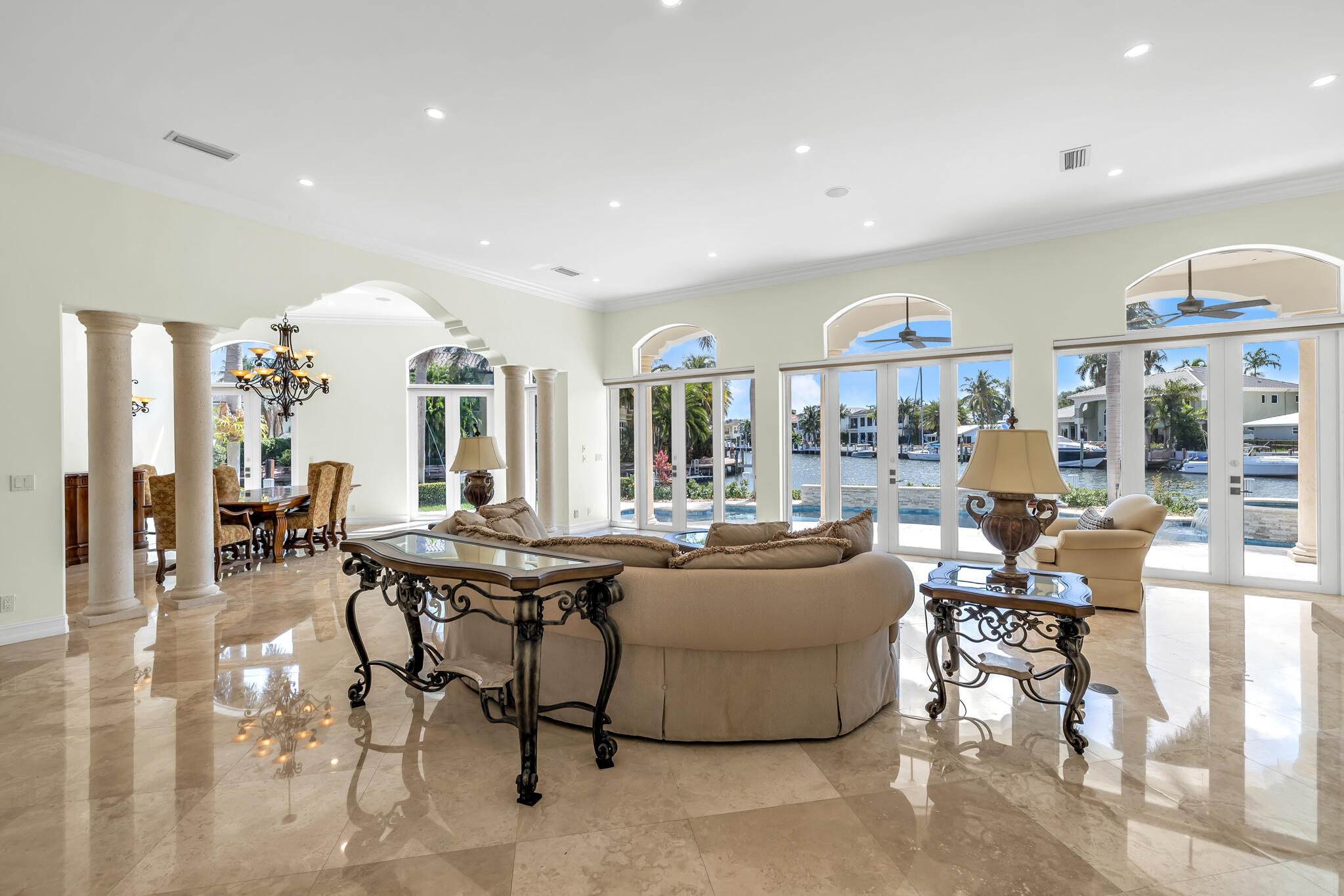 3700 Northeast 28th Avenue Lighthouse Point, FL 33064 - Photo 20 of 77 a living room with furniture a large window and chandelier