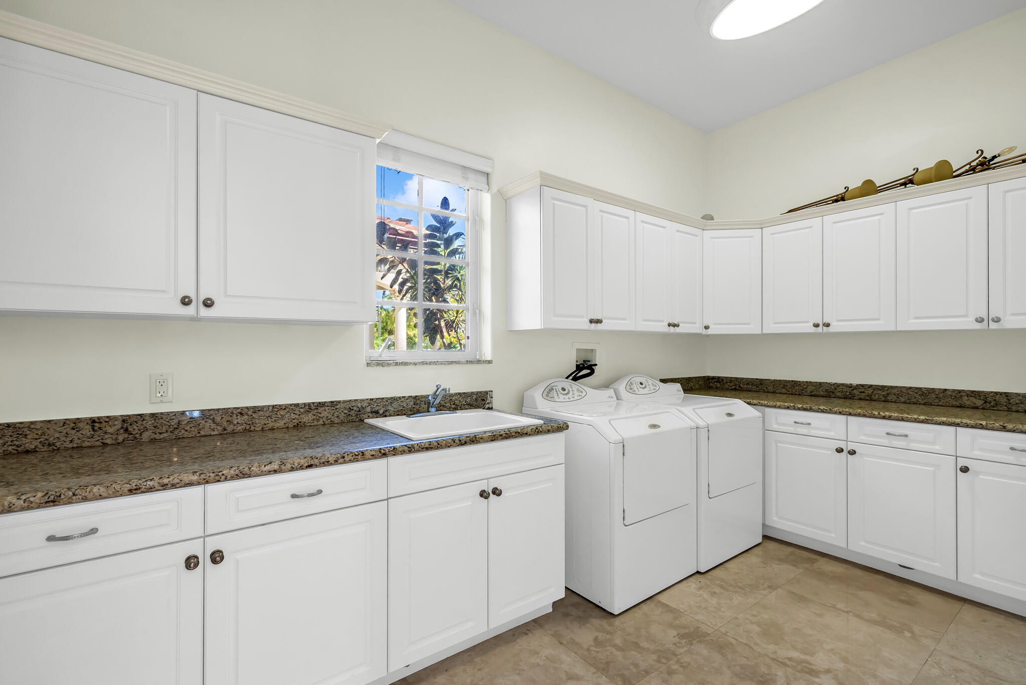 3700 Northeast 28th Avenue Lighthouse Point, FL 33064 - Photo 47 of 77 a kitchen with stainless steel appliances granite countertop a sink and dishwasher with white cabinets