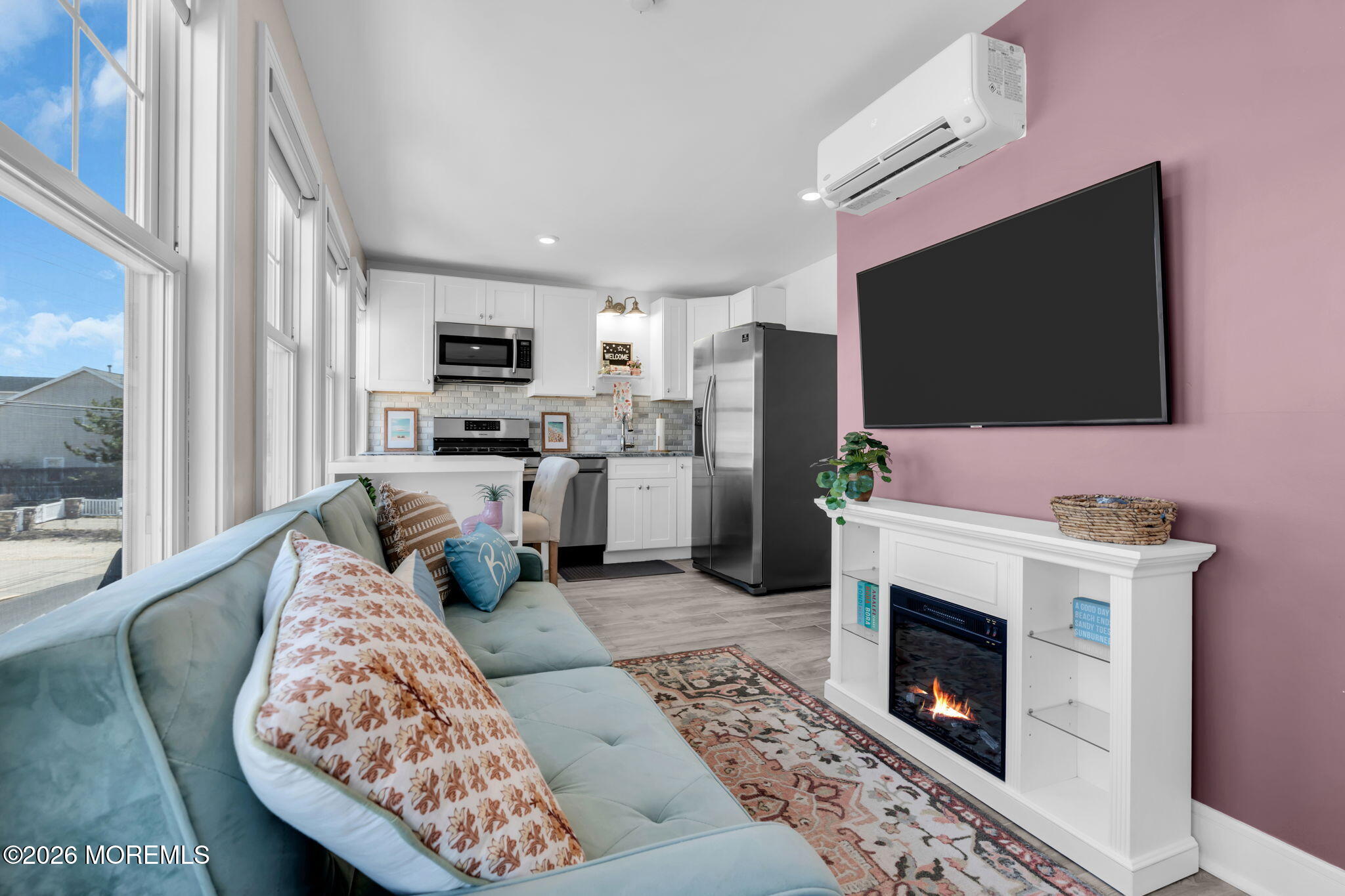 1301 Ocean Avenue, Unit 4 Point Pleasant Beach, NJ 08742 - Photo 2 of 13 a living room with furniture a flat screen tv and a fireplace