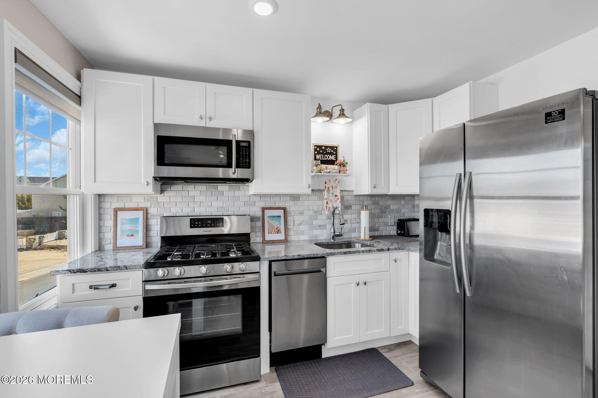 1301 Ocean Avenue, Unit 4 Point Pleasant Beach, NJ 08742 - Photo 5 of 13 a kitchen with cabinets stainless steel appliances and a counter space