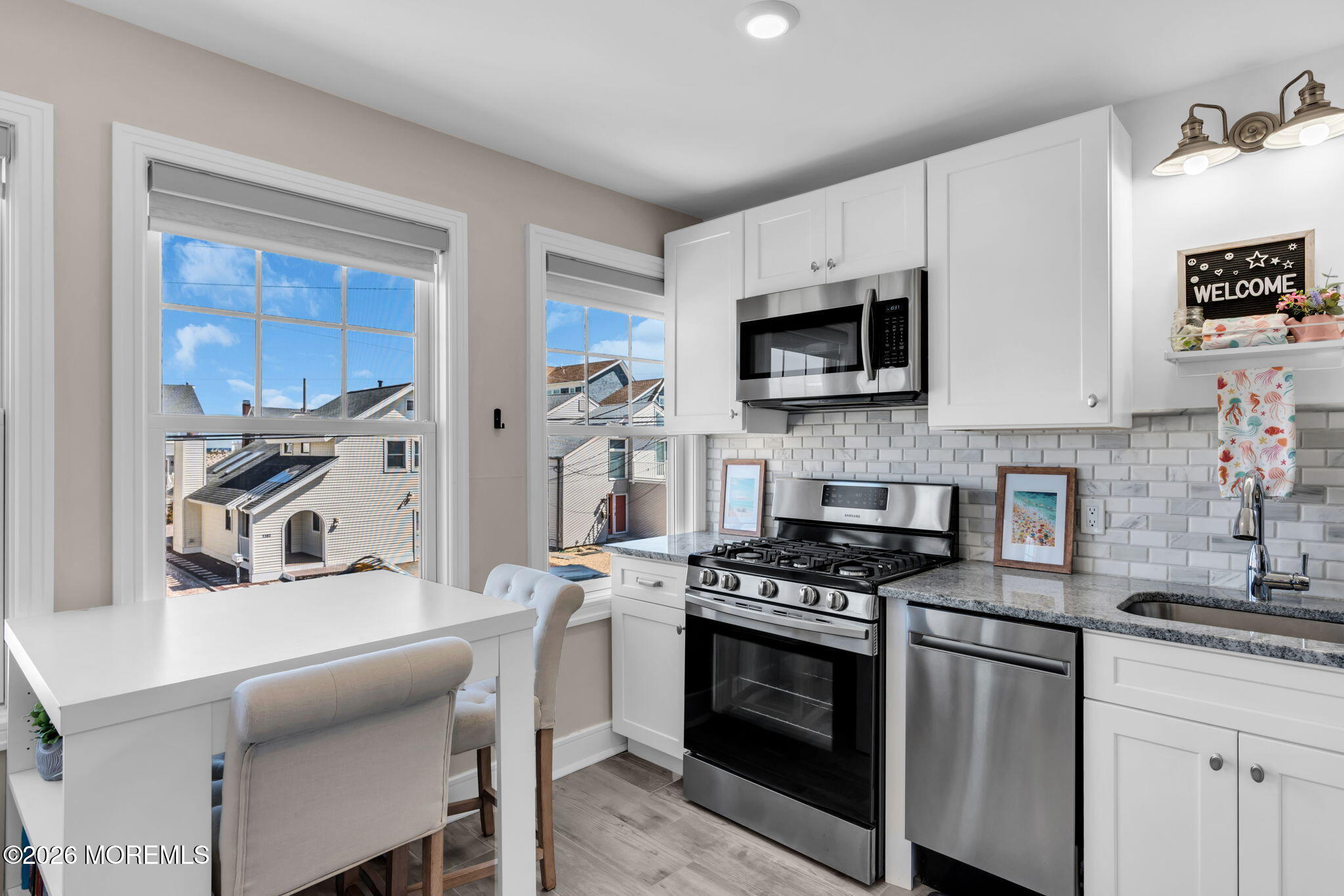 1301 Ocean Avenue, Unit 4 Point Pleasant Beach, NJ 08742 - Photo 6 of 13 a kitchen with stainless steel appliances a stove microwave and sink