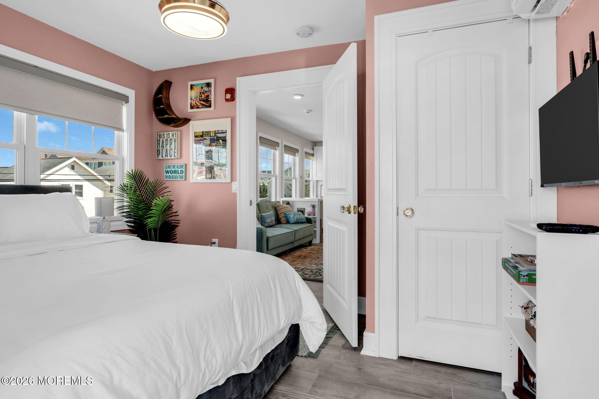 1301 Ocean Avenue, Unit 4 Point Pleasant Beach, NJ 08742 - Photo 10 of 13 a bedroom with a bed and a flat tv screen on wall