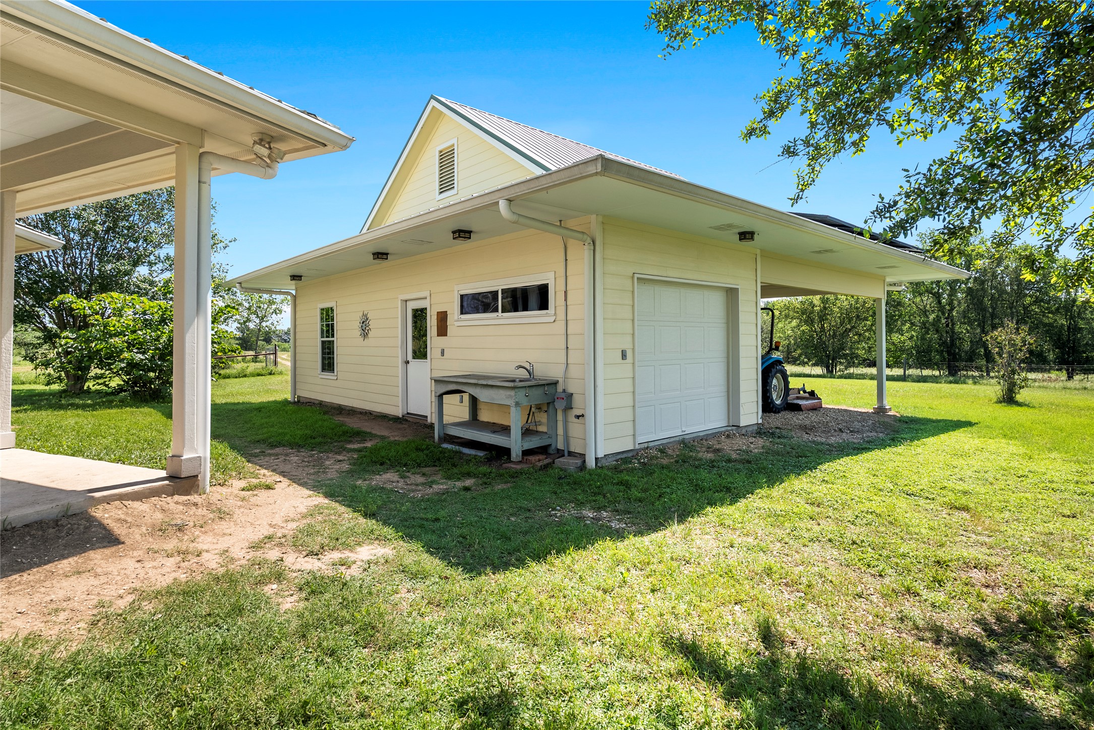928 Upper Elgin River Road Elgin, TX 78621 - Photo 7 of 40 Detached single-car garage and an integrated carport