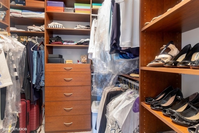 700 North Larrabee Street, Unit 115 Chicago, IL 60654 - Photo 11 of 20 a view of walk in closet with clothes and shoes