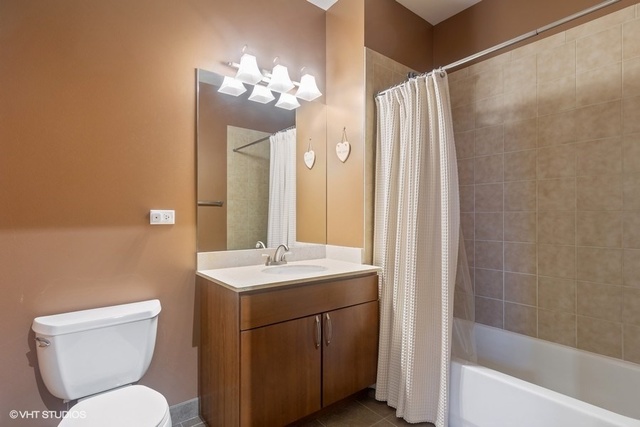 700 North Larrabee Street, Unit 115 Chicago, IL 60654 - Photo 13 of 20 a bathroom with a toilet sink and mirror