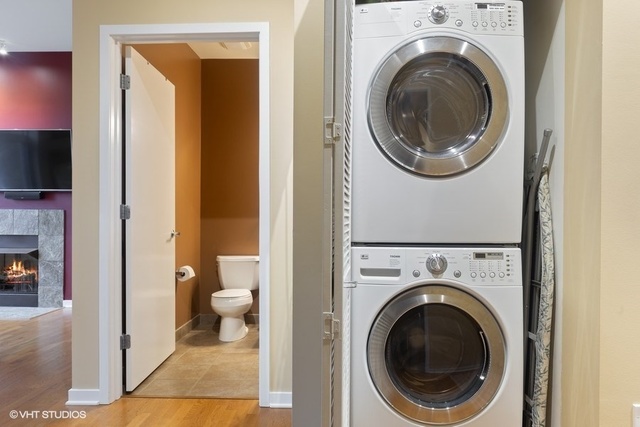 700 North Larrabee Street, Unit 115 Chicago, IL 60654 - Photo 14 of 20 a view of a hallway with washer and dryer