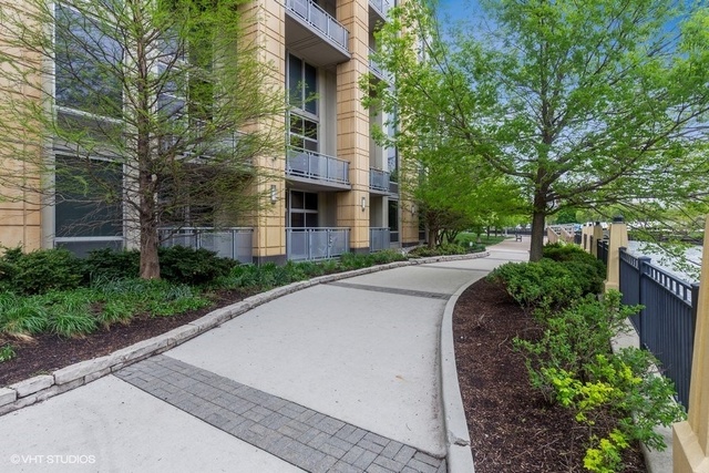 700 North Larrabee Street, Unit 115 Chicago, IL 60654 - Photo 19 of 20 a pathway of a house with a yard and large trees