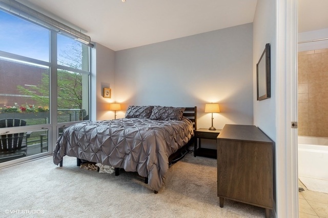 700 North Larrabee Street, Unit 115 Chicago, IL 60654 - Photo 9 of 20 a bedroom with a bed and large window