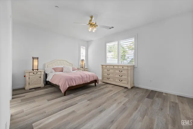 a spacious bathroom with double sink and mirror