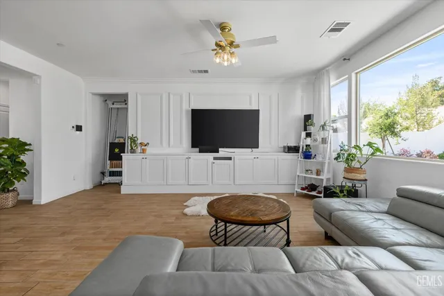 a kitchen with stainless steel appliances a sink a stove a refrigerator and cabinets