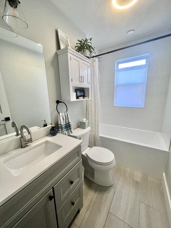 27 Armandine Street, Unit 3 Boston, MA 02124 - Photo 13 of 17 a bathroom with a toilet sink and mirror